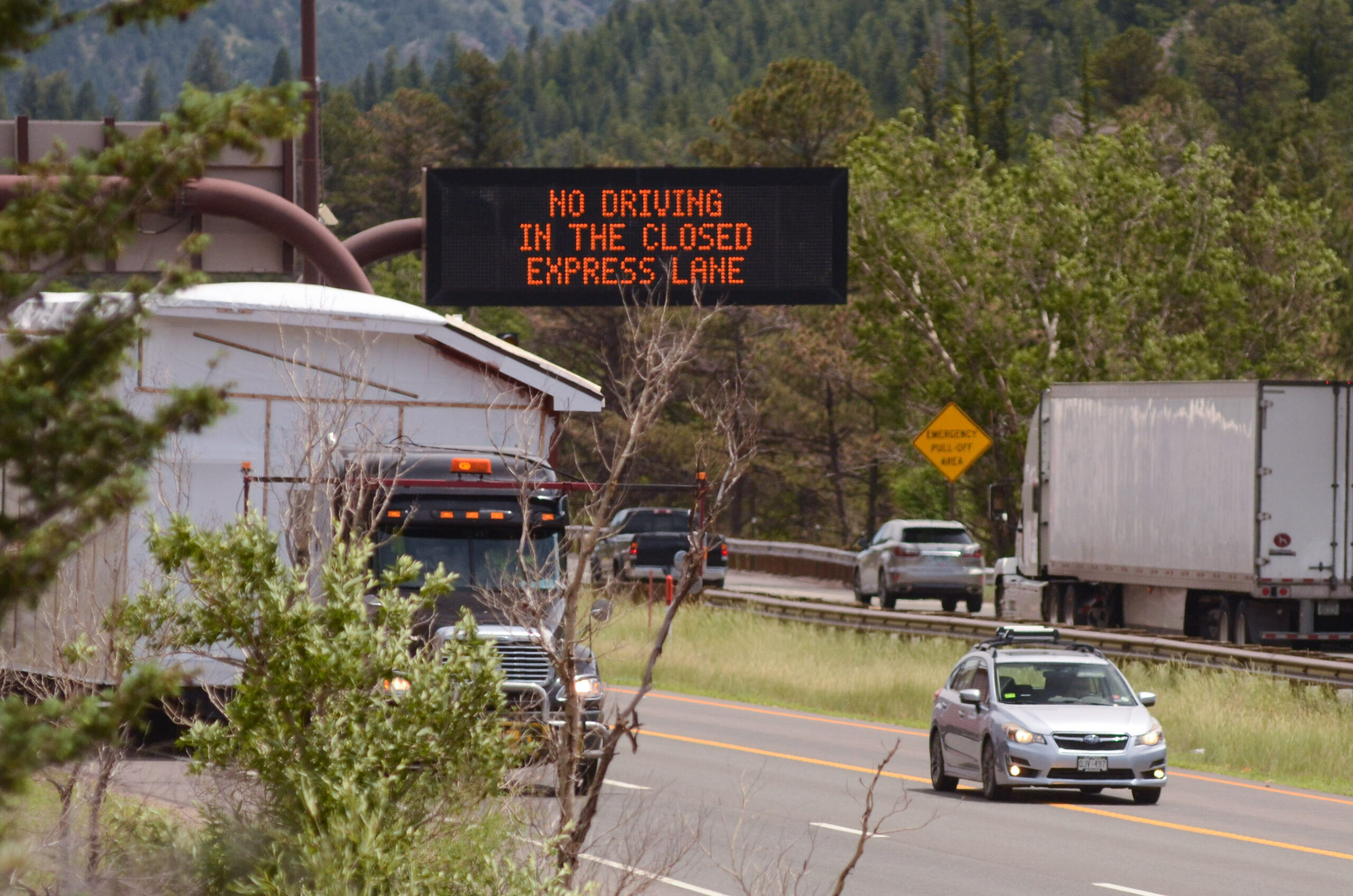 A sign on Interstate 70 west of Idaho Springs warns drivers about toll lane rules in July 2023. 