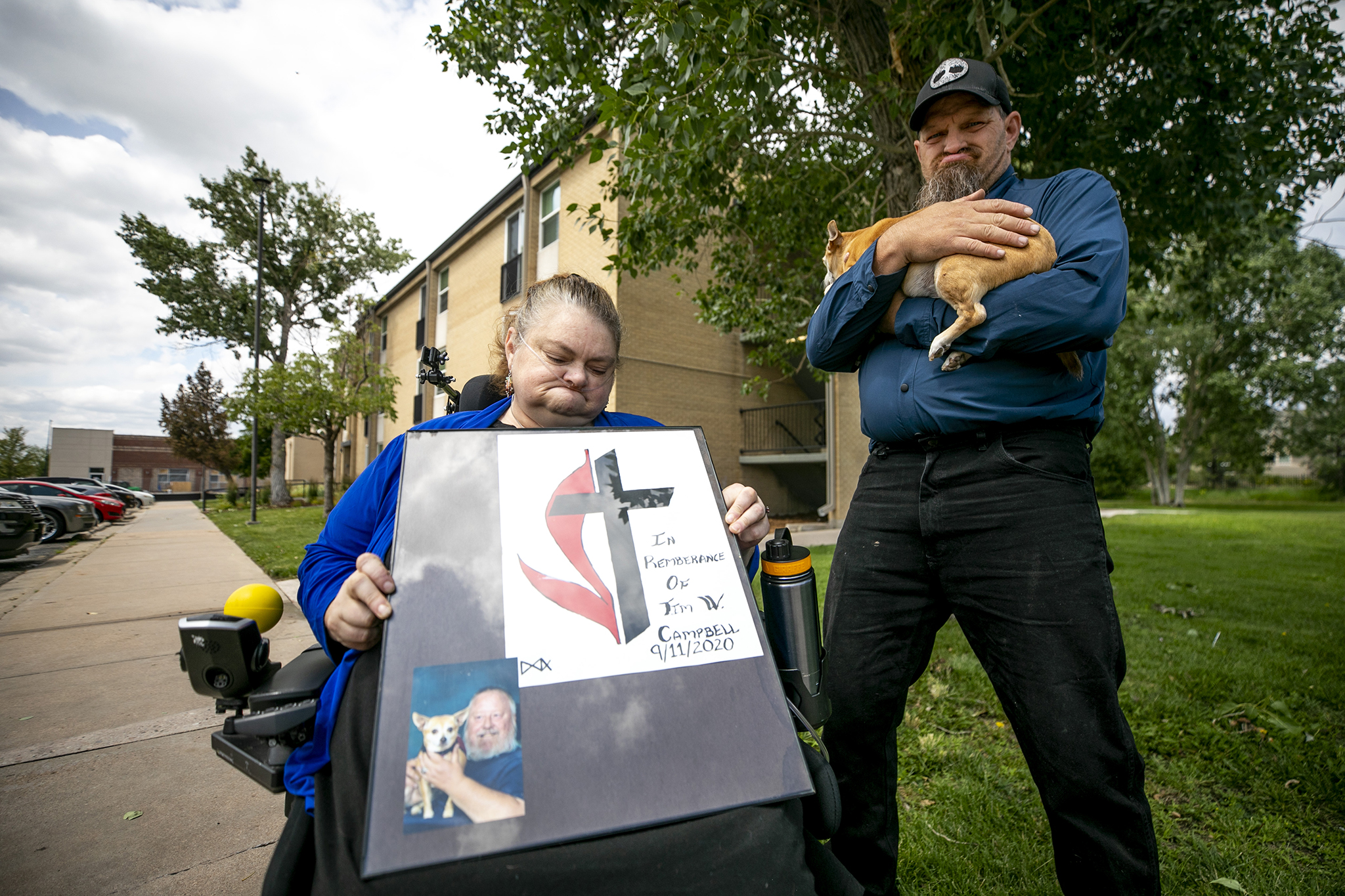 Alita and Dan Anderson outside of their Lowry home with a memorial for Tim Campbell, Alita&#039;s uncle who was killed by a driver on West Colfax Avenue. July 7, 2023.