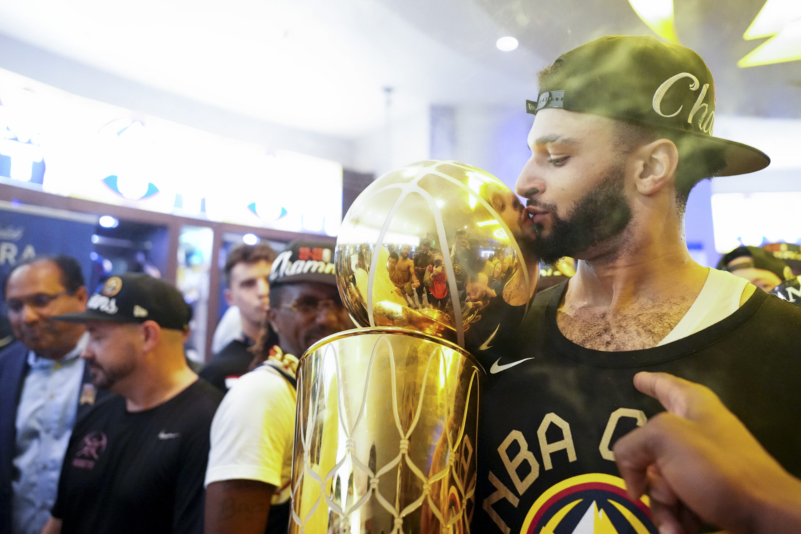 The Denver Nuggets&#039; Jamal Murray kisses the Larry O&#039;Brien NBA Championship Trophy inside the locker room after the team won the NBA Championship with a victory over the Miami Heat in Game 5 of basketball&#039;s NBA Finals, Tuesday, June 13, 2023, in Denver.