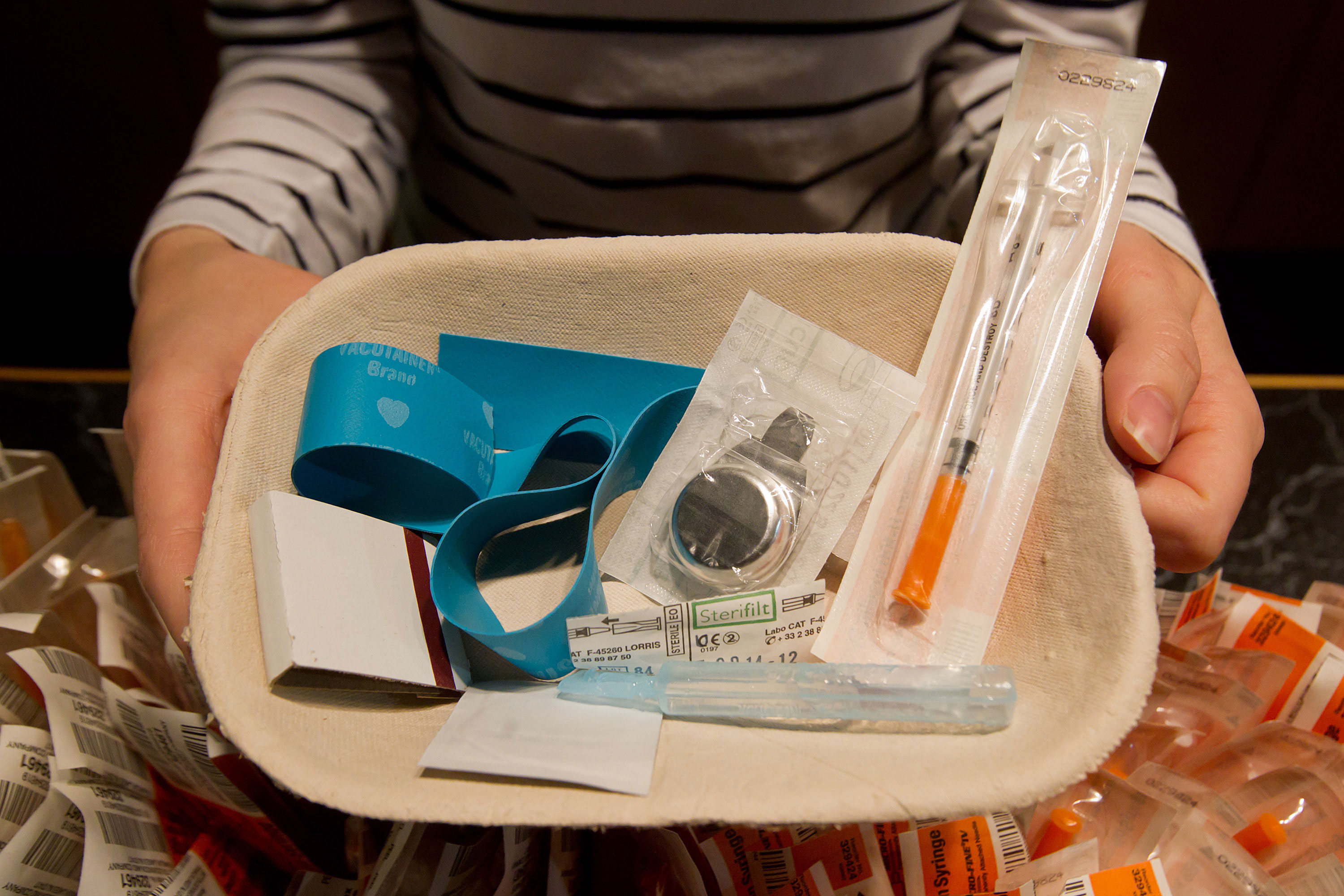 Registered nurse Sammy Mullally holds a tray of supplies to be used by a drug addict at the Insite safe injection clinic in Vancouver, B.C., May 11, 2011.