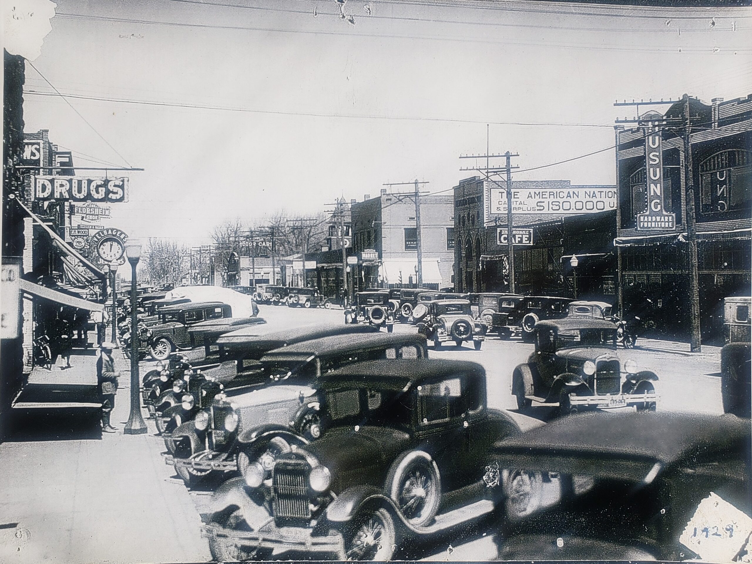 A downtown Alamosa street scene circa 1929 featuring the Velhagen Brothers Jewelry clock (at left) on State Avenue.