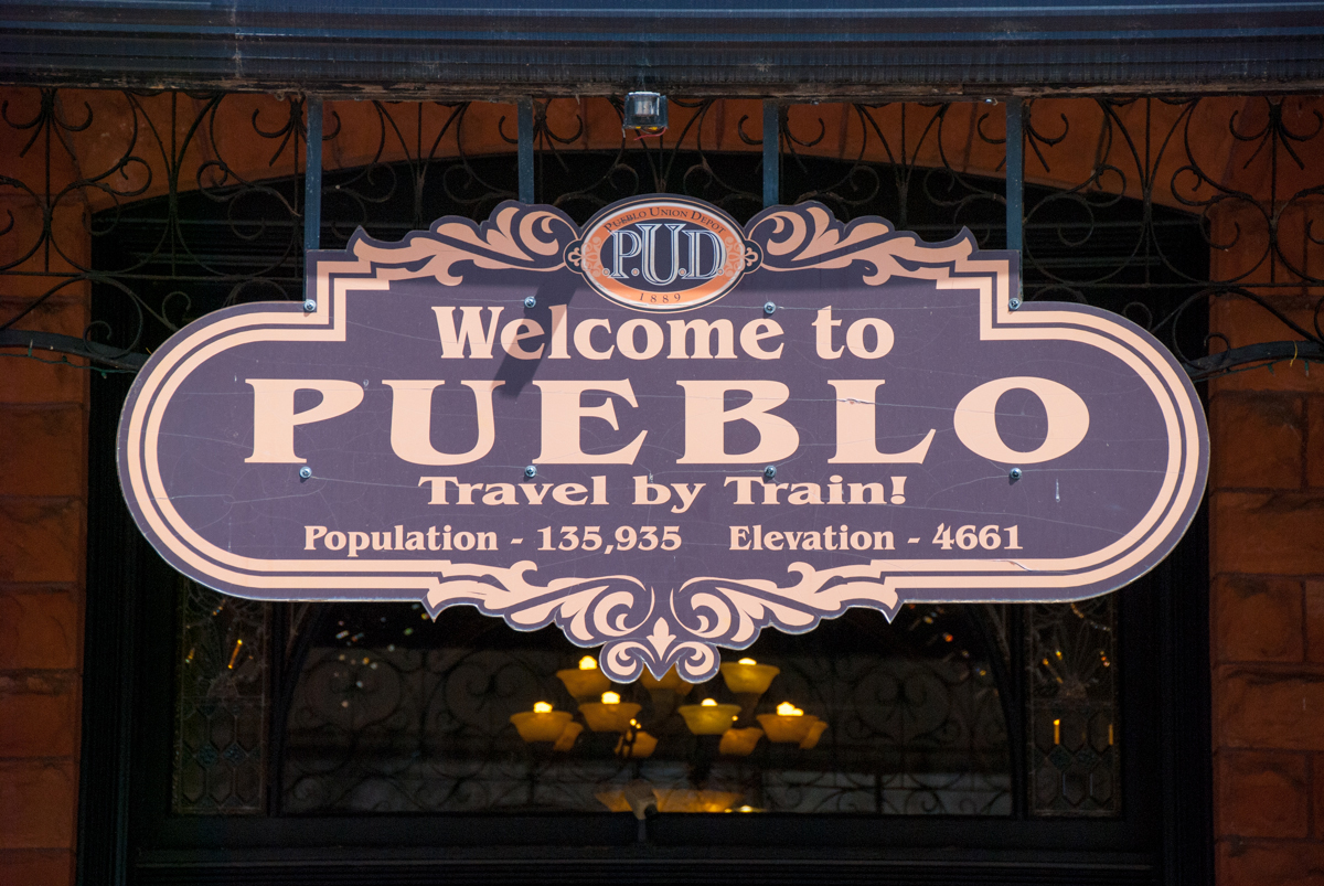 A sign at Pueblo&#039;s Union Depot advertises travel by rail