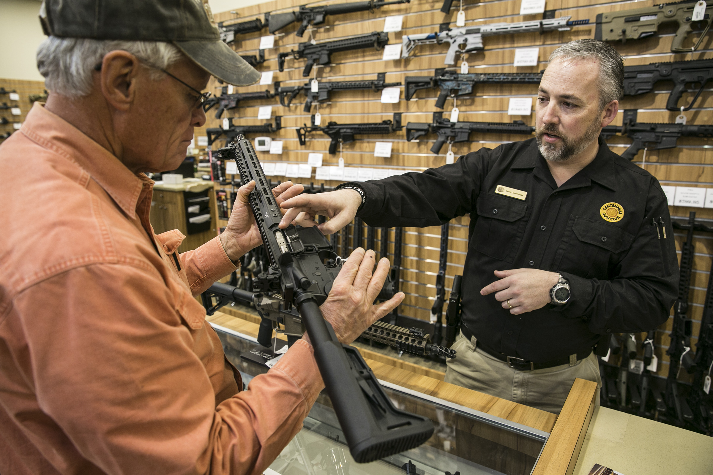 Mike Cummings with the Centennial Gun Club points out features on a long gun to customer Jim Collier of Centennial, Colorado on Wednesday, Nov 2. 2016.