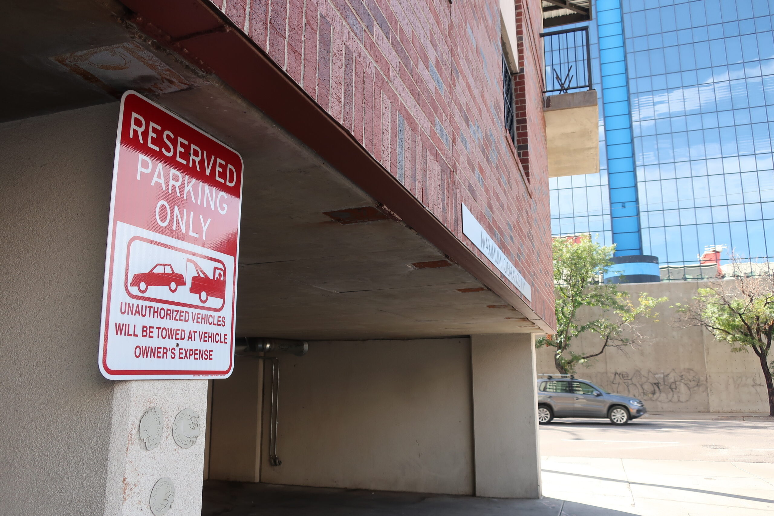 A sign threatens towing in an apartment complex parking lot in Denver. 