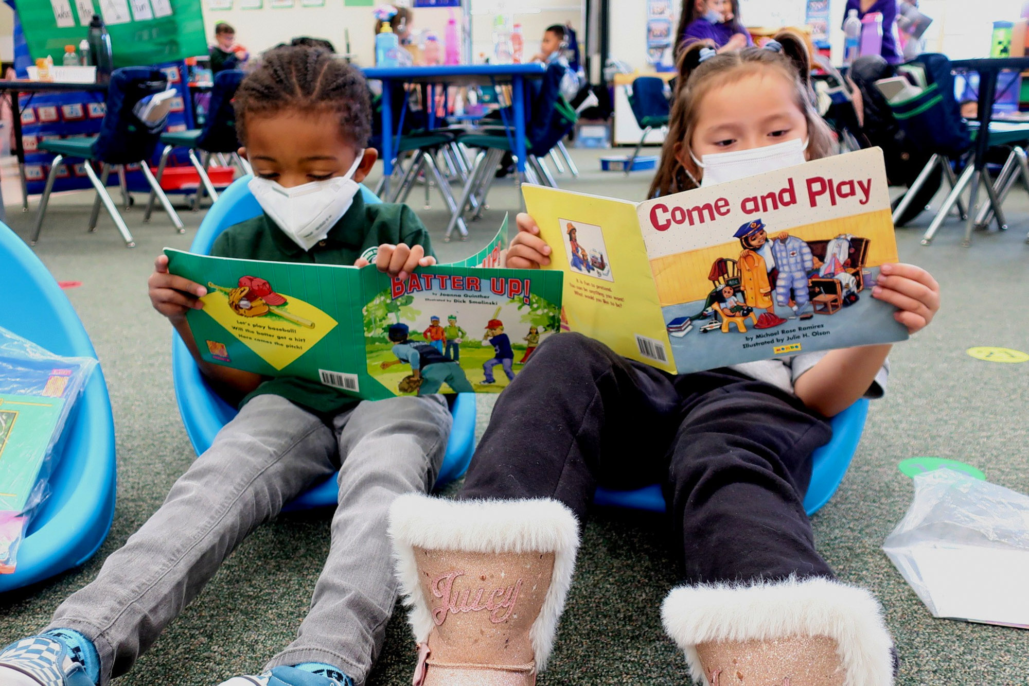 Two Kindergarten students take a moment to practice reading. Students came back to school at all different levels. They spent much more time on classroom routines and how to process multiple step directions than in a typical year.